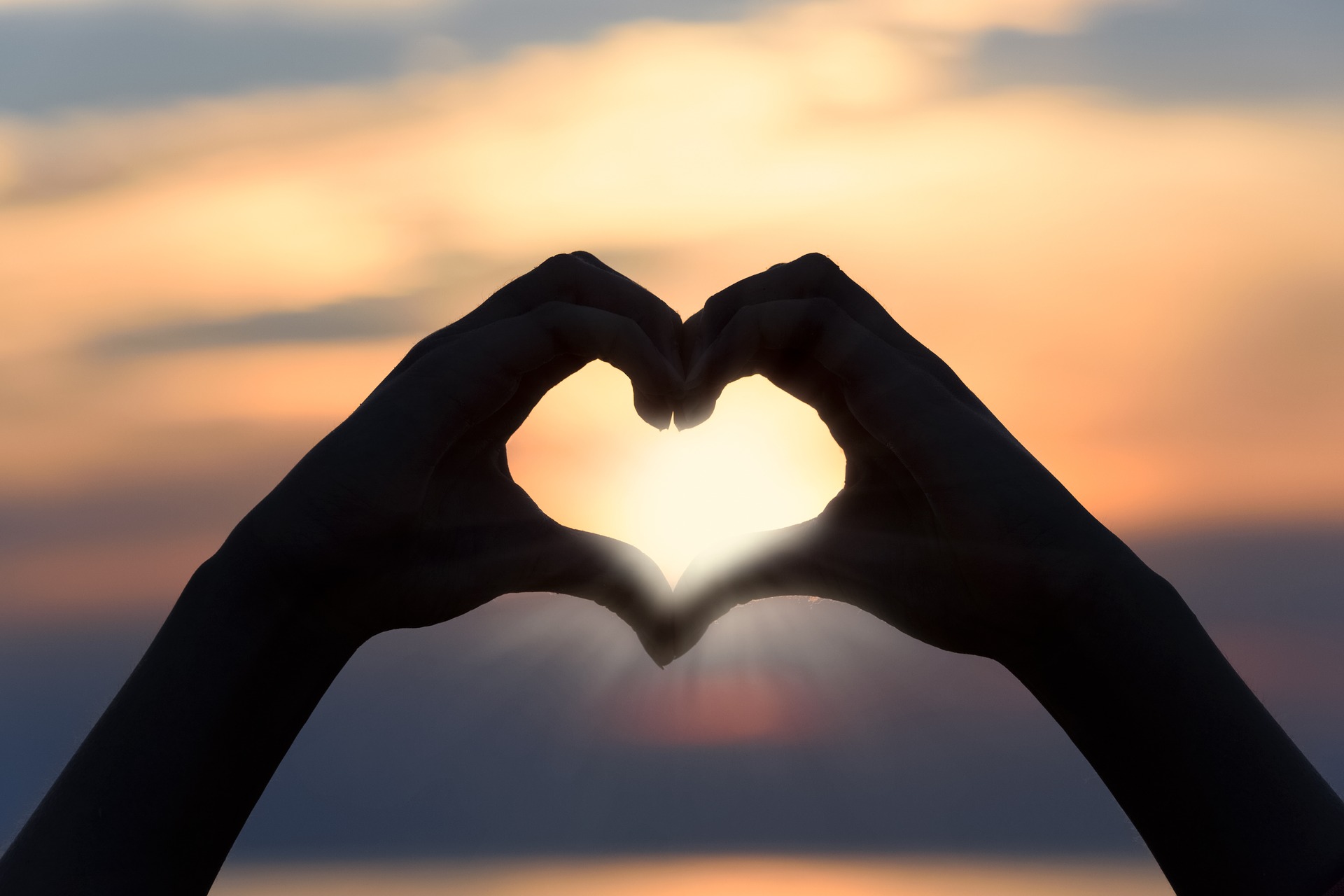 Silhouette of hands making a heart shape