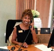 Roxanne Halliday at a desk on the phone